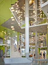 Entrance Lobby with "butterfly" LED Chandelier. The main entrance on level 01 brings users directly into the atrium, thereby promoting a sense of community within the school. - Photo Credit: Brad Feinknopf