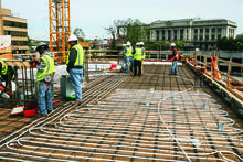 Radiant tubing installation in the structural concrete slab. - Photo Credit: Behnisch Architekten